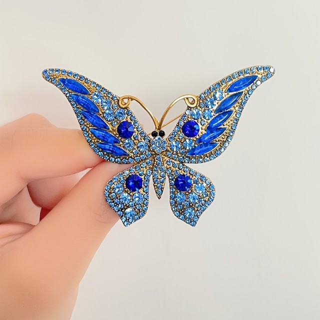 Sofisticirana modra broška v obliki metulja