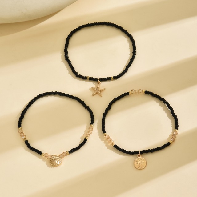 Komplet 3 zapestnic za nogo v črno - zlati kombinaciji