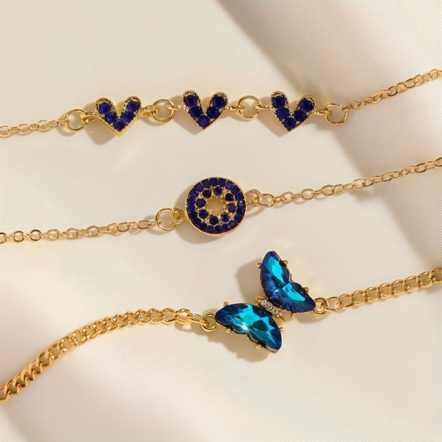 4 delni komplet zapestnic v zlatih odtenkih z modrimi dragulji 