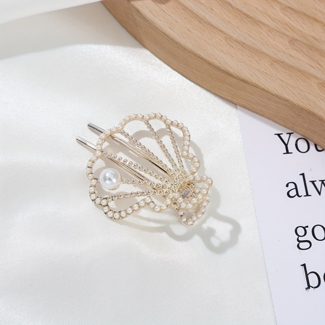 Elegantna kovinska sponka za lase v obliki školjke