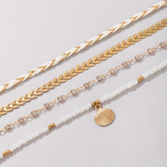 Komplet 4 modnih zapestnic z zlato školjko