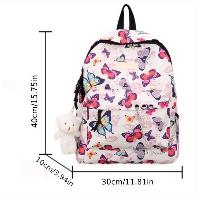 Moden nahrbtnik z barvitimi metulji in obeskom medvedka