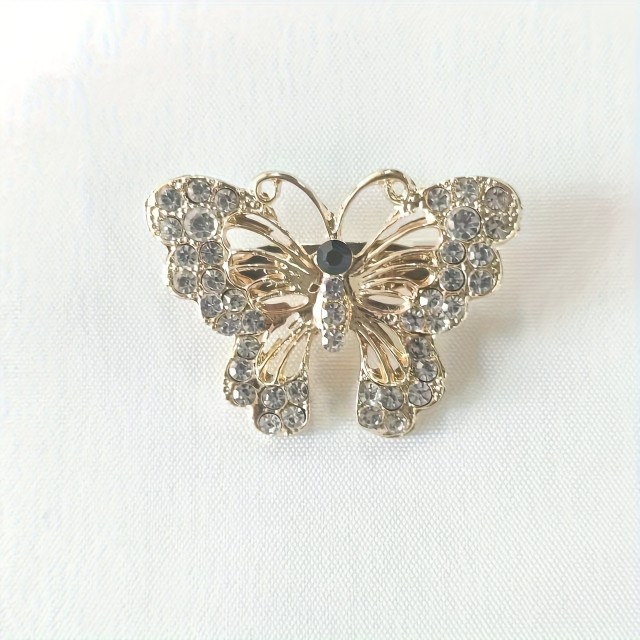 Elegantna črnozlata broška v obliki metulja