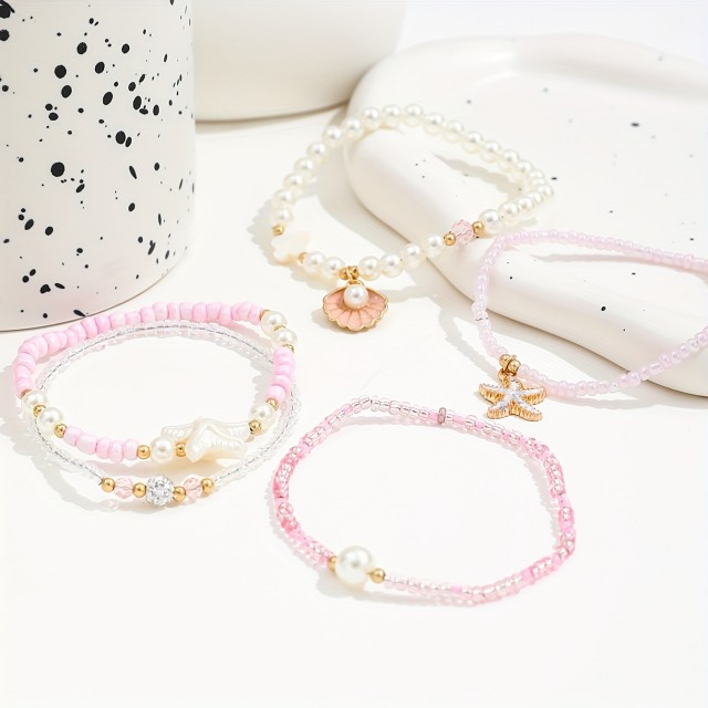 5 delni boho set zapestnic v roza barvi s školjkami