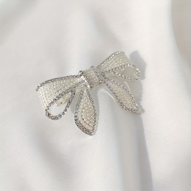 Lasna sponka v obliki pentlje v srebrni barvi 