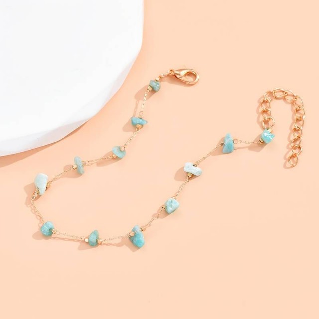 Zapestnica za nogo z modrimi kamenčki v zlati barvi