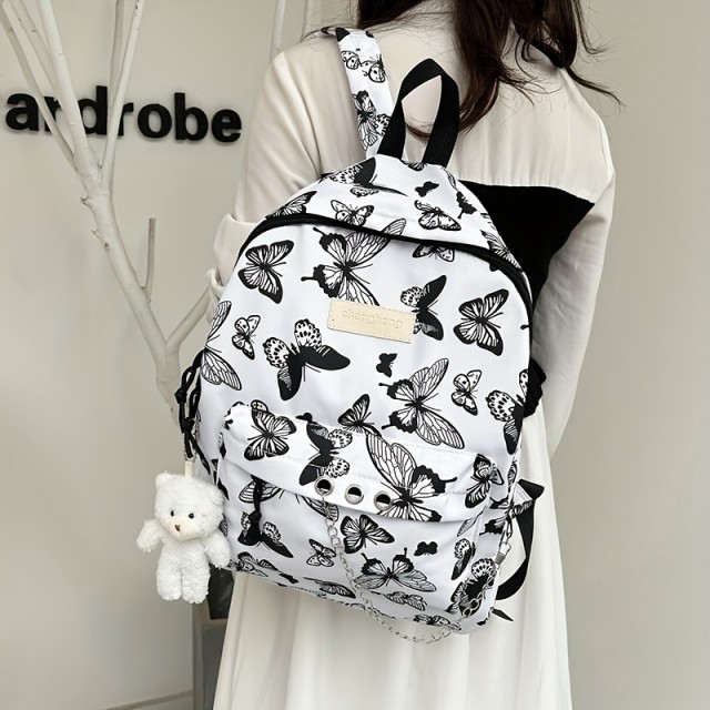 Prikupen črno-bel nahrbtnik z metulji in obeskom medvedka