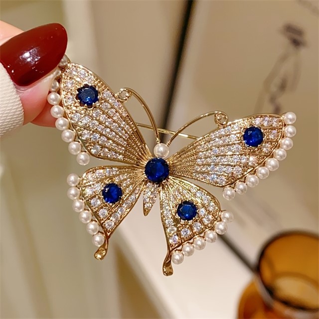 Elegantna broška metulj z biseri in modrimi kamenčki