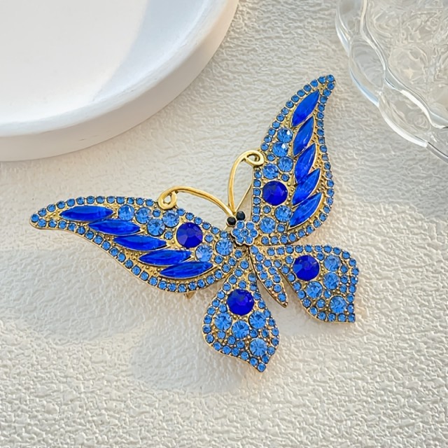 Sofisticirana modra broška v obliki metulja