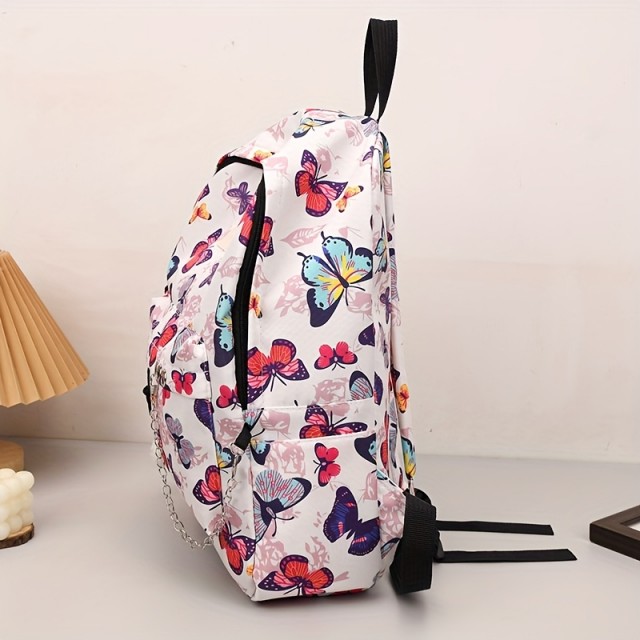 Moden nahrbtnik z barvitimi metulji in obeskom medvedka