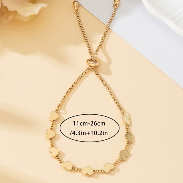 Nastavljiva ženska zapestnica s srci zlate barve