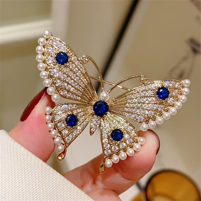 Elegantna broška metulj z biseri in modrimi kamenčki