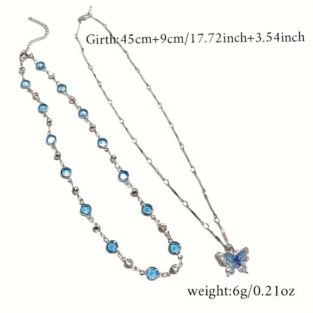 2 delni komplet ogrlic z modrimi kristalčki in metuljem