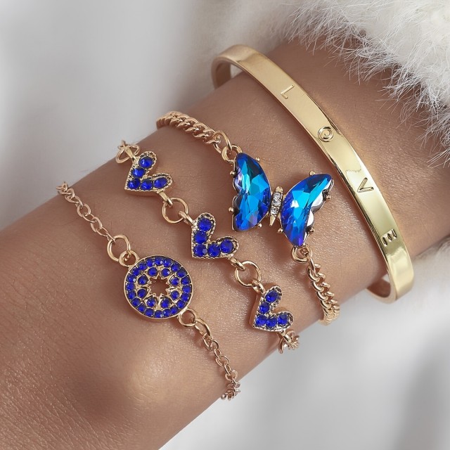 4 delni komplet zapestnic v zlatih odtenkih z modrimi dragulji 