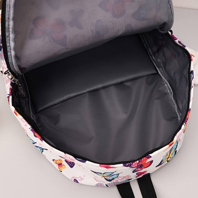 Moden nahrbtnik z barvitimi metulji in obeskom medvedka