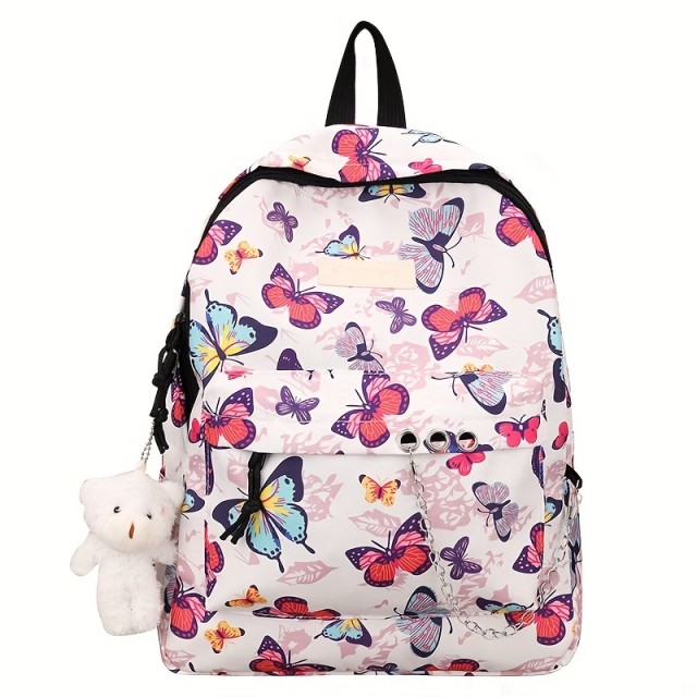 Moden nahrbtnik z barvitimi metulji in obeskom medvedka