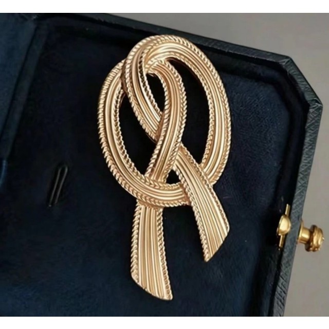 Elegantna zlata broška v obliki preste 