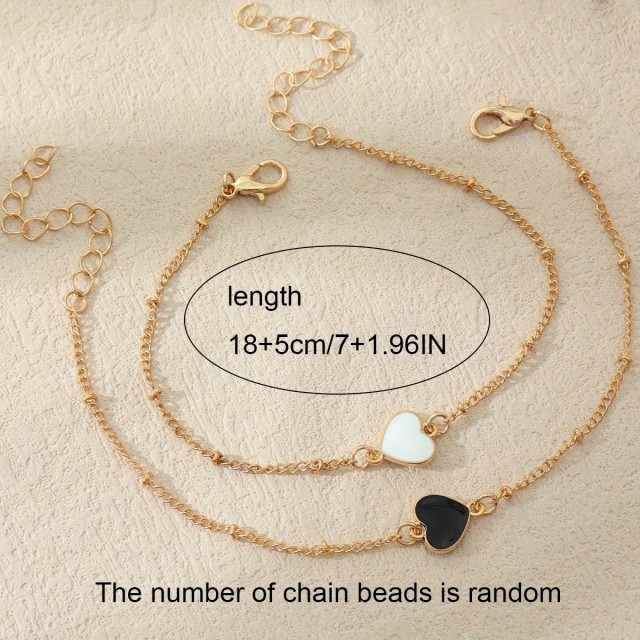 Komplet 2 nerjavečih zapestnic z belim in črnim srcem