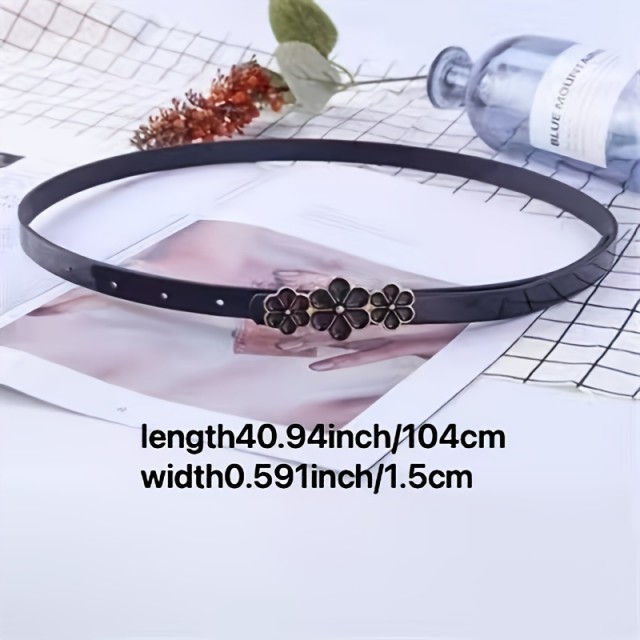 Eleganten črn pas z okrasnimi cvetličnimi detajli