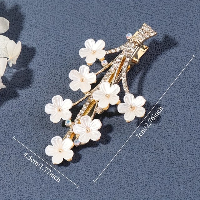 Elegantna cvetlična sponka za lase – zlati detajli