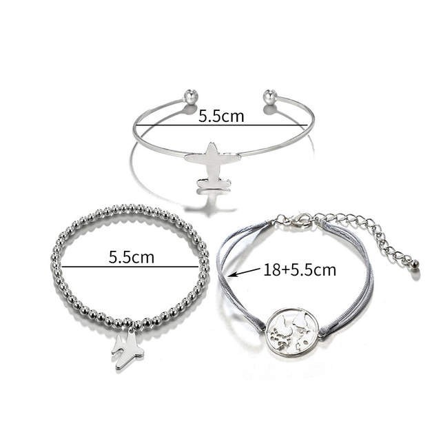 Komplet zapestnic z letalom in svetom v srebrni barvi 